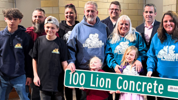 Neupert Family (Lion Concrete) holding sign at board meeting