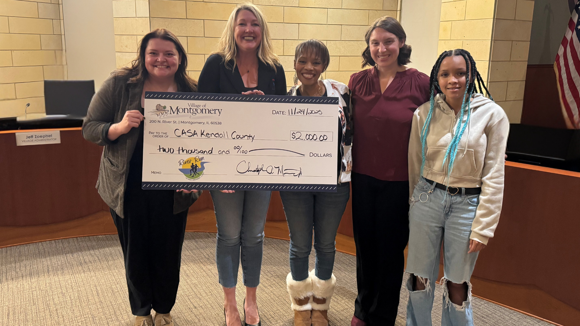 Women holding check to CASA of Kendall County